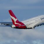 FILE - A Qantas A380 takes off from Sydney Airport over Botany Bay in Sydney, Australia, Monday, Sept. 5, 2022. Australian national carrier Qantas posted an underlying pre-tax half-year profit of 1.43 billion Australian dollars ($978 million) on Thursday, Feb. 23, 2023, in the airline's first return to profit since the coronavirus pandemic started three years ago. (AP Photo/Mark Baker/File)