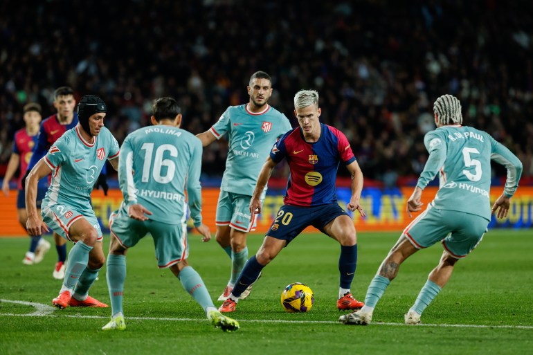 Barcelona's Dani Olmo, controls the ball during the Spanish La Liga soccer match between Barcelona and Atletico Madrid at the Lluis Companys Olympic Stadium in Barcelona, Spain, Saturday, Dec. 21, 2024. (AP Photo/Joan Monfort)